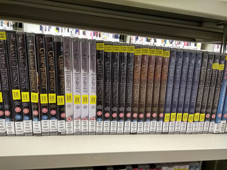 Image of shelf containing the DVDs of seasons 1-7 of Game of Thrones