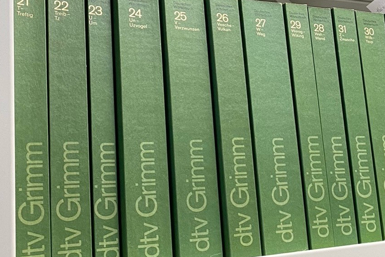 Large green books sit on shelving.
