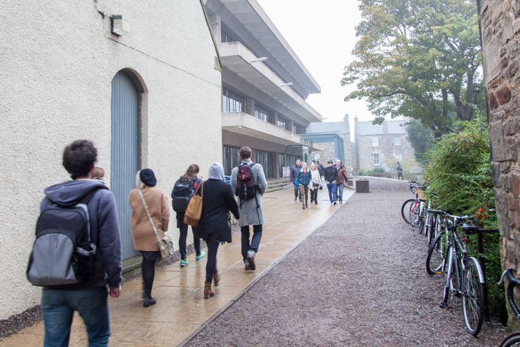 students walking toward Main Library in rain