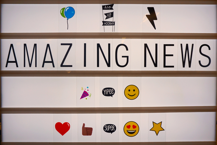 Lightbox spelling out Amazing News with letters and emojis