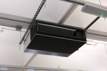 Black metal box is shown fitted to a white ceiling.